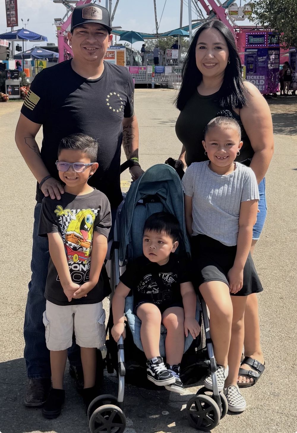 Pastor Charlie and Carina Salazar with their three children, Penelope, Emmanuel and Niko, at the county fair